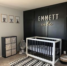 a black and white nursery with an emmet cafe sign above the crib in the corner