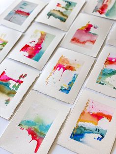 many different colored paintings on white paper