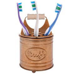 three toothbrushes in a wooden holder on a white background