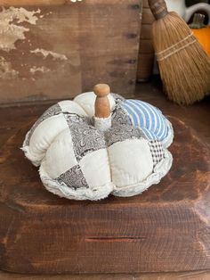 a wooden table topped with a white and blue pumpkin sitting on top of a piece of wood