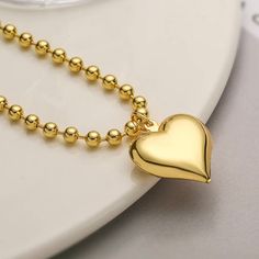 Unleash your bold and radiant style with our 'Max' Large Heart Chain Necklace. Crafted with non-tarnish 18K gold plating and durable stainless steel, this necklace exudes elegance and adds a touch of sophistication to any outfit. Elevate your look with this statement piece that radiates luxury and quality. 18k gold plated stainless steel Non tarnish Pendant Size (inch): 1 x 1 Chain Length (inch): 15 Extension Length (inch): 2 Trendy Gold Heart Necklace With Chain, Trendy Gold Heart Pendant Chain Necklace, Trendy Gold Chain Necklace With Heart Pendant, Trendy Gold Necklaces For Valentine's Day, Trendy Gold Necklace For Valentine's Day, Gold Stainless Steel Necklace With Heart Charm, Gold Stainless Steel Heart Necklace With Adjustable Chain, Gold Stainless Steel Heart Necklace For Valentine's Day, Heart Chain Necklace