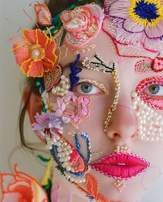 a woman with flowers painted on her face