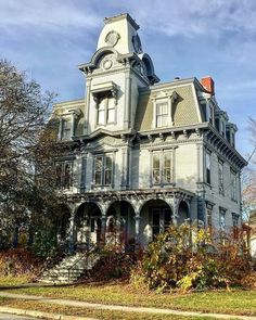 an old house with a clock on the top of it