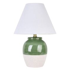 a green and white ceramic lamp with a white shade on the top, against a white background