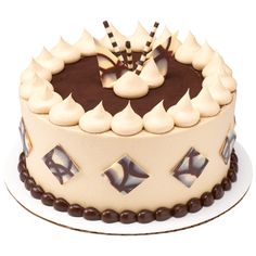 a cake with white frosting and chocolate decorations