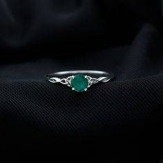 Product Details Introducing the Simple Solitaire Ring, a dazzling masterpiece featuring a magnificent round shape Emerald as its striking solitaire, securely cradled in a four-prong setting. This ring boasts an intricately designed Celtic shank, adding a touch of timeless charm to its elegance. It serves as a perfect token of love, making it an ideal gift for your beloved, destined to be cherished for a lifetime. Product Information SKU SHP-RINGS0721120654 Width 3.5 mm Height 5 mm Weight 2.40 gm (Approximate) EMERALD INFORMATION No.of Stones 1 Pieces Total Weight 0.50 Carat (Approximate) Dimension(approx) Round-5X5 mm-1 Pcs Color Green Cut Brilliant Shape Round Setting Type Prong-Setting Quality Grade AAA View More Product Parent Collection Handle emerald-rings Emerald Solitaire Ring, Ring Sizer, Emerald Ring, Yellow Gold Rings, Solitaire Ring, Prong Setting, Round Shape, Ideal Gift, Gold Rings