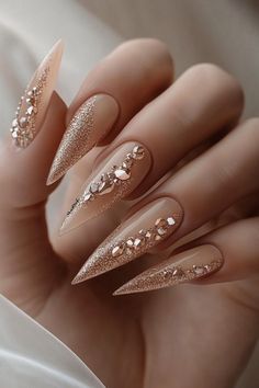 Add drama to your look with these nude stiletto nails, enhanced with glittering rose gold designs. Perfect for elegant winter nails or a trendy goth winter vibe. Find more trendy winter nails at nailhow.com. Save this gorgeous pin for later! 🌟❄️. Elegant Winter Nails, Nude Stiletto Nails, Trendy Winter Nails, Goth Winter, Rose Gold Nails Glitter, Silk Wrap Nails, Nail Prices, Nail Techniques, Winter Color Palette