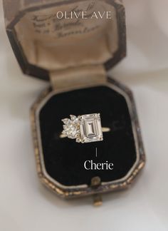 an engagement ring in a box with the words cherre written on it's side