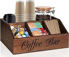 a wooden coffee bar with cups and paper napkins in the bottom compartment, on a white background