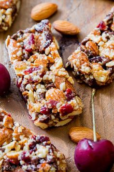 granola bars with cherries and almonds on a wooden board, ready to be eaten