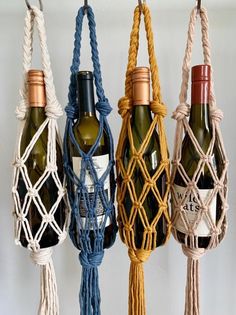 four bottles of wine are hanging from rope