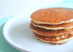 a stack of pancakes sitting on top of a white plate