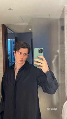 a man taking a selfie in front of a mirror