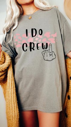 a woman with blonde hair wearing a grey t - shirt that says i do crew