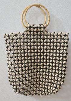 This wooden bag is made of bamboo material and natural beads.  It is lightweight and perfect for the beach. The size is approximately 26 inches in length and 12 inches wide. NOTE: THIS ITEM SHIPS WITHIN THE US ONLY Summer Beaded Rectangular Beach Bag, Summer Vacation Beaded Beach Bag, Summer Vacation Beaded Shoulder Bag, Beaded Crochet Rectangular Bag For Beach, Bohemian Beaded Beach Bag For Summer, Bohemian Beaded Rectangular Beach Bag, Beaded Crochet Beach Bag For Summer, Beaded Beach Bags For Beach Season, Bohemian Beaded Crochet Bag For Beach