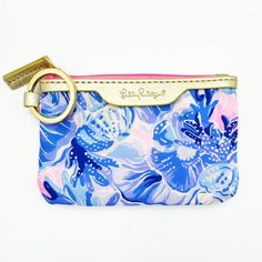 a blue and pink flowered purse with a gold keychain