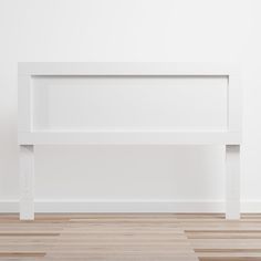 a white shelf sitting on top of a hard wood floor next to a white wall