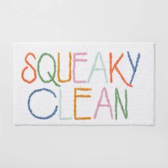 the word sqeaky clean is painted on a white towel with multicolored letters