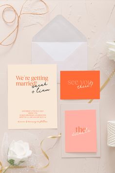 the wedding stationery is laid out on top of each other