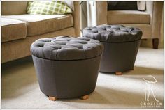 two grey ottomans sitting on top of a carpeted floor next to a couch and chair