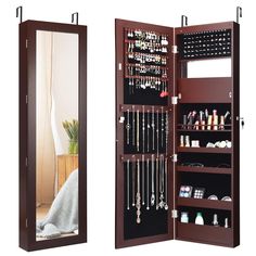 a large mirror is open to show the inside of a jewelry cabinet