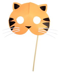 a paper tiger mask on top of a stick