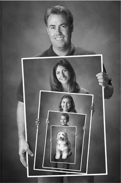 a black and white photo of a man holding up a frame with photos of people on it