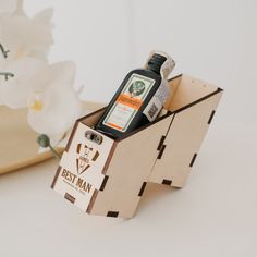 an empty bottle in a wooden box on a table