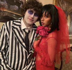 a man and woman dressed up as beetleman and lady with makeup on their faces