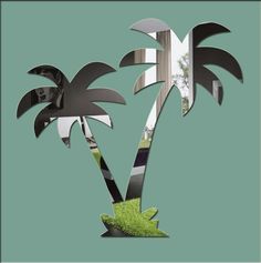 a palm tree cut out of metal on a green background with an image of a woman in the middle