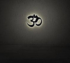 a black and white photo with the word om in it's center on a brick wall