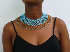 African beaded shawl necklaces, Beaded cape necklaces, Beaded wedding necklace, Statement necklace, Christmas gift for her, Tribal necklace A 100% handmade in Kenya necklace. Can fit any body type as it layers well with the body *Color: light blue and gold *Necklace height:  3 inch/7 cm *Neck size length : 13.5 inch / 34 cm (Adjustable and extends up to 16 inch/ 41cm * Available in different colors. Please select your color (Gold color remains constant) * 3-5 days delivery via shipping via DHL E Wedding Beaded Necklaces With Tiny Beads, Wedding Tiny Beads Necklace, Gift Bib Necklace With Large Beads, Adjustable Beaded Necklaces For Celebration, Beaded Bridal Necklace Gift, Gold Beads Bib Necklace Gift, Celebration Beads With Large Beads, Blue And Gold Necklace, African Beaded Necklace