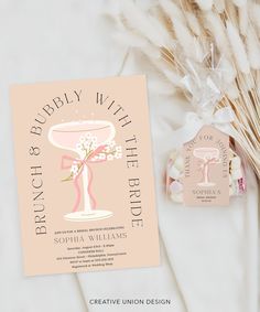 the wedding stationery is displayed next to some dried flowers and pamperant sticks