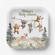 a baby shower tray with animals hanging from clothesline and forest scene in the background