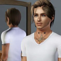 a man with tattoos standing in front of a mirror