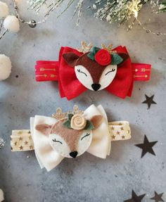 two christmas hair clips on top of a table