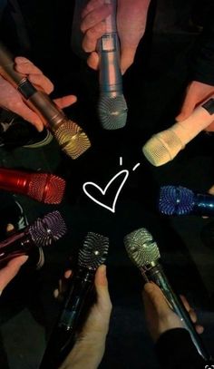 a group of people holding microphones with the word love written on them