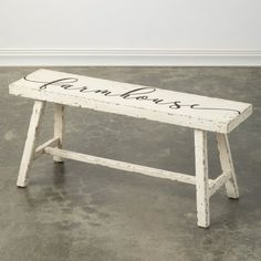 a white bench with writing on it