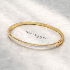 Indulge in the brilliance of this 1.35-carat baguette diamond bangle bracelet, meticulously crafted in lustrous 14K gold. Each baguette diamond is expertly set to maximize its radiant sparkle, promising a captivating presence on any wrist. As a lab-grown diamond, it offers the same exceptional beauty and durability as a natural diamond, while respecting the environment. Whether it's an unforgettable anniversary gift or a cherished addition to your jewelry collection, this statement piece will un Anniversary Cubic Zirconia Bangle With Baguette Diamonds, White Gold Bangle With Baguette Diamonds, Elegant Cubic Zirconia Bangle With Baguette Diamonds, White Diamond Bracelet With Baguette Diamonds For Gift, Classic Bangle With Baguette Diamonds Cut, Modern Diamond Bangle With Baguette Cut, Fine Jewelry Bangle With Baguette Diamonds For Gift, Modern Baguette Cut Diamond Bangle, Elegant Bangle With Baguette Cut Diamonds