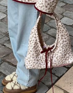 a person wearing slippers and holding a purse