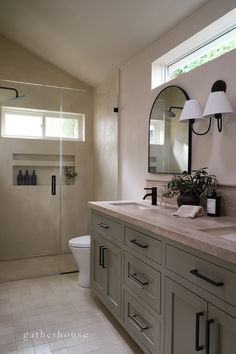 a bathroom with a sink, toilet and shower stall in the middle of the room