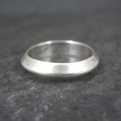 This beautiful, vintage band ring is sterling silver. Measurements: 4mm wide Size: 6 Marks: Tribal, Sterling Condition: Excellent Silver Stackable Dome Ring For Wedding, Classic Thick Band Rings Stamped 925, Classic Sterling Silver Wide Band, Silver Stackable Dome Ring For Promise, Classic Sterling Silver Stackable Wide Band Rings, Classic Sterling Silver Wide Band Stackable Rings, Classic Sterling Silver Stackable Rings With Wide Band, Heirloom Style Silver Stackable Rings With Round Band, Heirloom Silver Ring With Thick Band