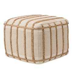 a white and brown striped ottoman sitting on top of a floor