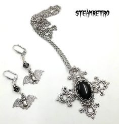 "This fantastic silver plated filigree cross necklace features a Swarovski black jet crystal and is part of our new Dark Gothic range, and is a step away from our previous steampunk work.The set comes complete with our spooky silver plated vampire bat earrings! There are numerous Gothic designers out there, and various marketplaces to purchase Gothic jewellery, but i am sure you will like what we are doing here Growing up in the 80's i lived through the \"goth\" movement, many a lost weekend was Silver Cross Jewelry For Halloween, Gothic Cross Pendant Jewelry For Halloween, Gothic Cross Jewelry For Gifts, Gothic Cross Jewelry As Gift, Gothic Cross Jewelry Gift, Gothic Ankh Necklace In Metal, Black Steampunk Jewelry For Halloween, Silver Cross Pendant Jewelry For Halloween, Halloween Silver Jewelry With Cross Pendant