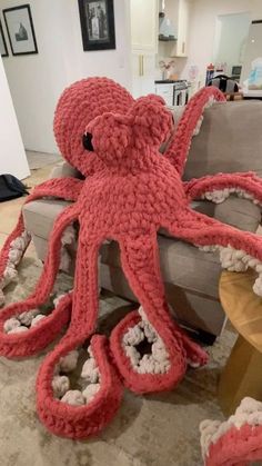 an octopus stuffed animal sitting on top of a couch