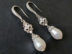 Wedding White Teardrop Pearl Silver Chandelier Bridal Statement Earrings. PLEASE READ ITEM DESCRIPTION and SHOP POLICIES before placing your order, and contact me with any questions! EARRINGS are about 1.57 inch (4cm) long from top of earring hook to bottom. BRIDAL EARRINGS SECTION: https://www.etsy.com/shop/LanaChayka?ref=seller-platform-mcnav§ion_id=11638940 BRIDAL JEWELRY SETS SECTION: https://www.etsy.com/shop/LanaChayka?ref=seller-platform-mcnav§ion_id=25839214 BRIDAL NECKLACES SECTION: htt Classic White Drop Chandelier Earrings, White Elegant Teardrop Dangle Earrings, White Elegant Dangle Teardrop Earrings, White Dangle Teardrop Earrings With Elegant Design, Wedding Bridal Drop Earrings With Ear Wire, Wedding Drop Bridal Earrings With Ear Wire, White Long Drop Teardrop Earrings For Wedding, Drop Earrings For Wedding With Ear Wire, Classic Long Drop Chandelier Earrings For Wedding