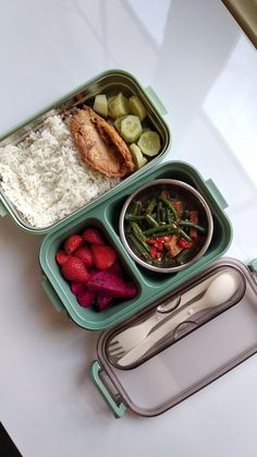 a lunch box with rice, strawberries, vegetables and meat in it on a table