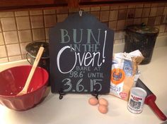 a sign that says bunn'n the oven and baking ingredients on a kitchen counter