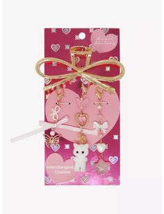 two heart shaped key chains in a pink package with a bow on the front and back