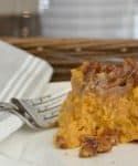 a piece of cake sitting on top of a white plate next to a knife and fork